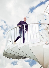 Stefan Gössling on an outdoor spiral staircase