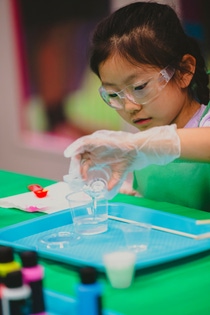 Young scientist makes chemistry magic with slime at the BASF Power Science Lab at the Children’s Museum Houston.