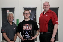 Brandon Rixse (center) receives his plaque for being named the North American representative for the R-M Best Painter contest from Roger Sipe, BASF Account Representative (left) and Mike Freeman, BASF Market Segment Manager for R-M in North America.