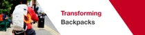 A person seen from behind on a bicycle wears a white backpack with VAUDE and BASF logo and an orange light ring. The text reads: "Transformed Backpacks." A person seen from behind on a bicycle wears a white backpack with VAUDE and BASF logo and an orange light ring. The text reads: "Transformed Backpacks."