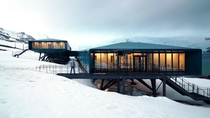 A barren, snowy Antarctic landscape with upcycled shipping containers standing on stilts above the snow in the foreground. The modular units have been used to build a scientific research station and accommodation blocks. A barren, snowy Antarctic landscape with upcycled shipping containers standing on stilts above the snow in the foreground. The modular units have been used to build a scientific research station and accommodation blocks.