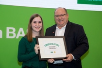 Kayla Beechinor accepts her scholarship award from BASF’s Scott Kay during the BASF Association Scholarship Presentation at Commodity Classic