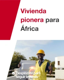 Un hombre que lleva un chaleco de seguridad amarillo y un casco está de pie delante de un edificio, sosteniendo una baldosa de construcción. Aparecen espirales de luz cerca de la mano de la persona. En el texto pone: “Viviendas pioneras para África”.
