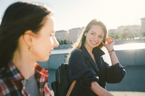 Cheerful young women cycling in the park in a sunny day.