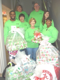 BASF employees take a moment to pause with some of the gifts being delivered to local agencies to support those in need. Pictured from left to right: Reggie Chambliss, Judy Bedwell, Bonita Walley, Chrissie James, and Quinici Howell. Back row left to right: Cathy Boyett and James McCormick.