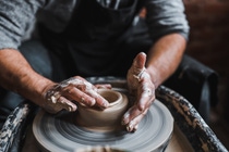 Two hands transforming clay into a vase Two hands transforming clay into a vase