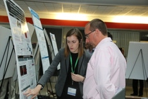 Bailey Risteen, a Ph.D. candidate from Georgia Institute of Technology, discusses her research poster with Gary Deeter, Research Scientist at BASF.