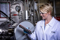 BASF is conducting global research into innovative cathode active materials that, depending on their composition, can be used in batteries for small to luxury cars. That’s how innovations from BASF are helping to further advance electromobility.BASF researcher Kathrin Michel checks test batteries that are investigated for several weeks under well-controlled temperature conditions. Even small test batteries provide very precise information about the future service life of the battery in an electric car.  Photo: BASF SE