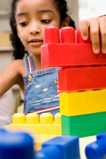 Girl playing with plastic blocks