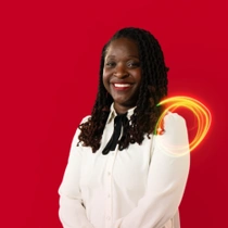 A female BASF employee in a white shirt standing against a red background, a light swirl hovers around the shoulder.