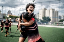 Two female soccer players celebrate their win
