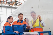 In order to equip a Boeing 777 with the fuel-saving surface technology on a large scale, BASF's cooperation partner Lufthansa Technik uses the aircraft's regular maintenance idle times. After a sophisticated design, the film patches are cut to size and attached exactly along the flow course of the fuselage and the engine nacelles. The application of about 2,000 patches is carried out in sections over several days by a trained team. In order to equip a Boeing 777 with the fuel-saving surface technology on a large scale, BASF's cooperation partner Lufthansa Technik uses the aircraft's regular maintenance idle times. After a sophisticated design, the film patches are cut to size and attached exactly along the flow course of the fuselage and the engine nacelles. The application of about 2,000 patches is carried out in sections over several days by a trained team.