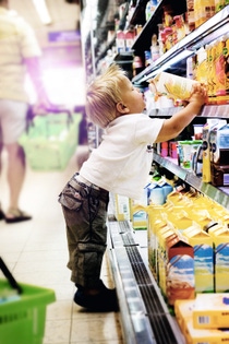 Little boy doing groceries in supermarket Little boy doing groceries in supermarket