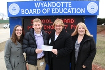 BASF employees Rachel Staran, Dan Niedzwiecki and BASF employee and Wyandotte Schools alumna Lia Simpson present a $7,000 donation to Dr. Catherine Cost, Wyandotte Public Schools Superintendent.
